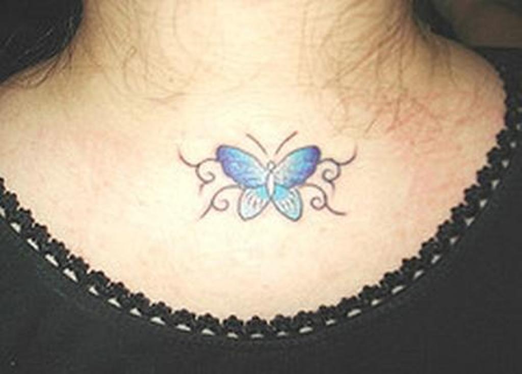 Small butterfly tattoo on front of neck