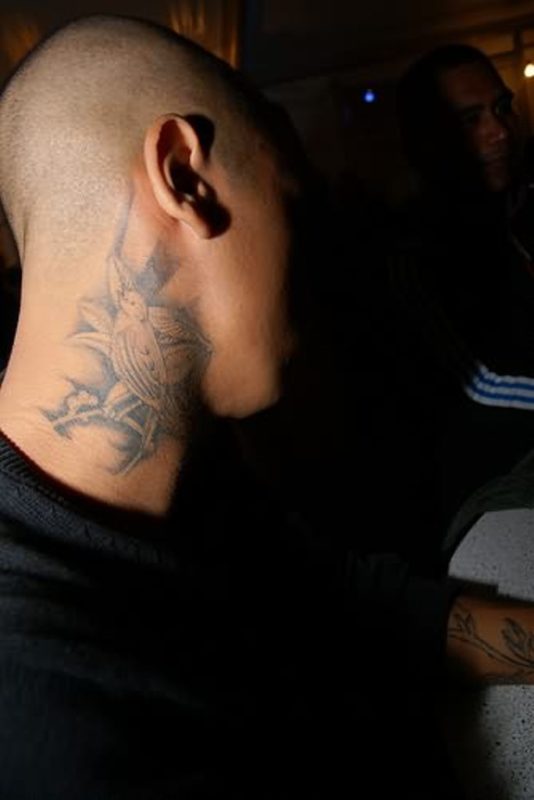 Grey Colored Bird Tattoo On Neck