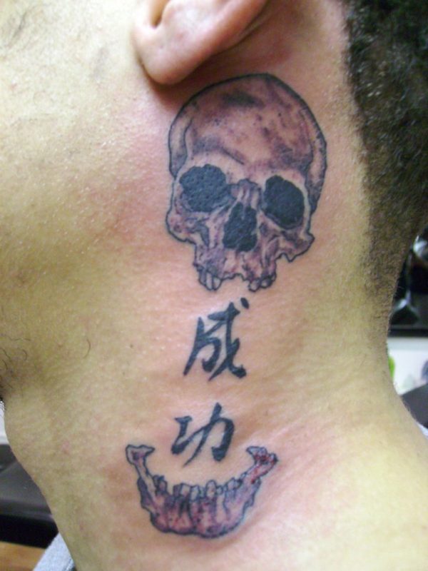 Kanji And Skull Tattoo On Neck