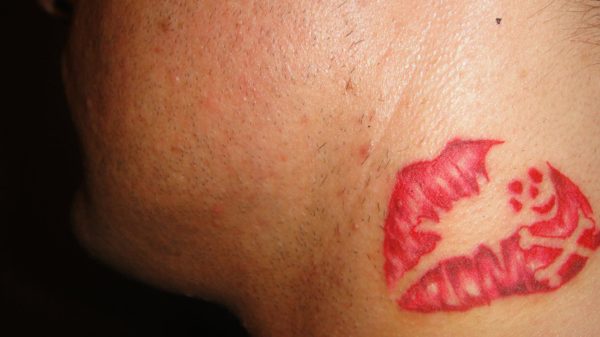 Neck red Kiss Mark tattoo