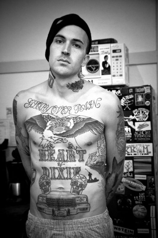 Pistol And Flower Design Tattoo On Yelawolf Neck