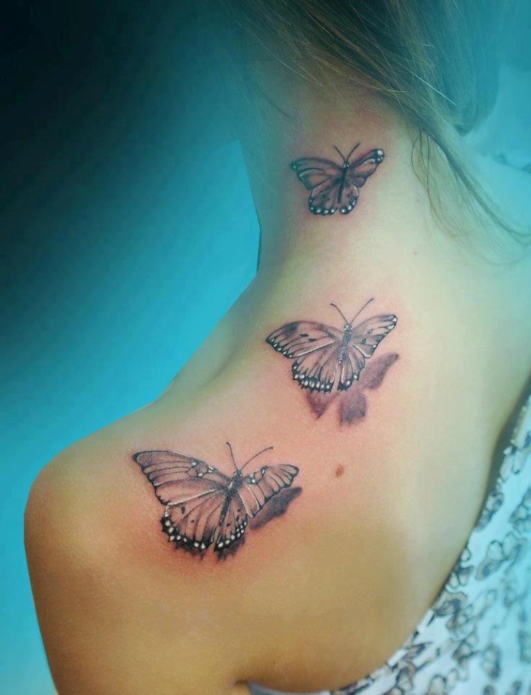 Butterfly neck and shoulder tattoo