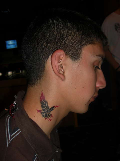 Red And Black Tattoo On Neck