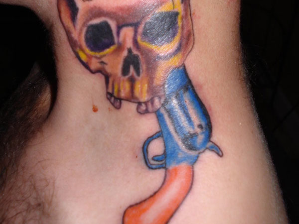 Skull And Gun Tattoo On Neck