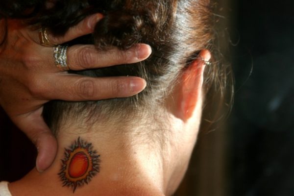 Stunning Orange Sun Tattoo On Neck